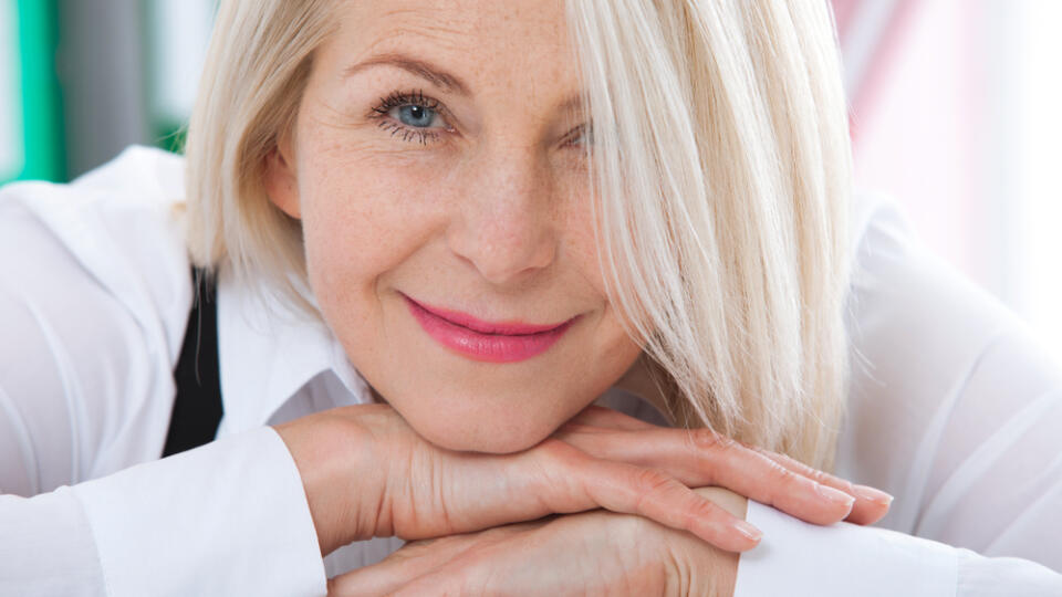 Lovely,Middle-aged,Blond,Woman,With,Beaming,Smile,Sitting,At,Office