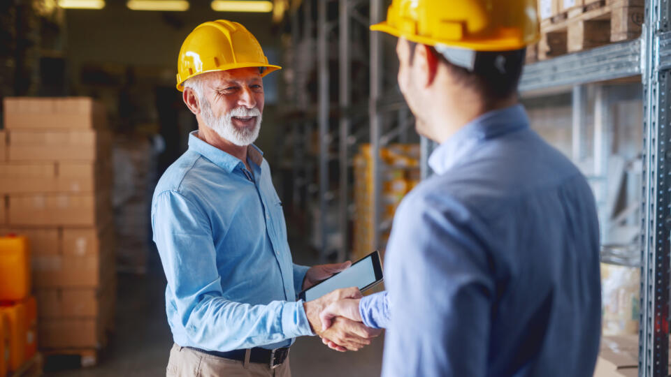 Two,Business,Partners,In,Formal,Wear,And,With,Helmets,On