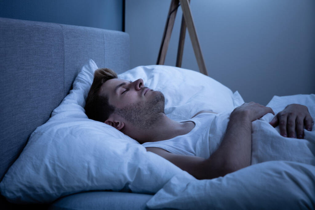 Young,Man,Sleeping,In,Bed,At,Home