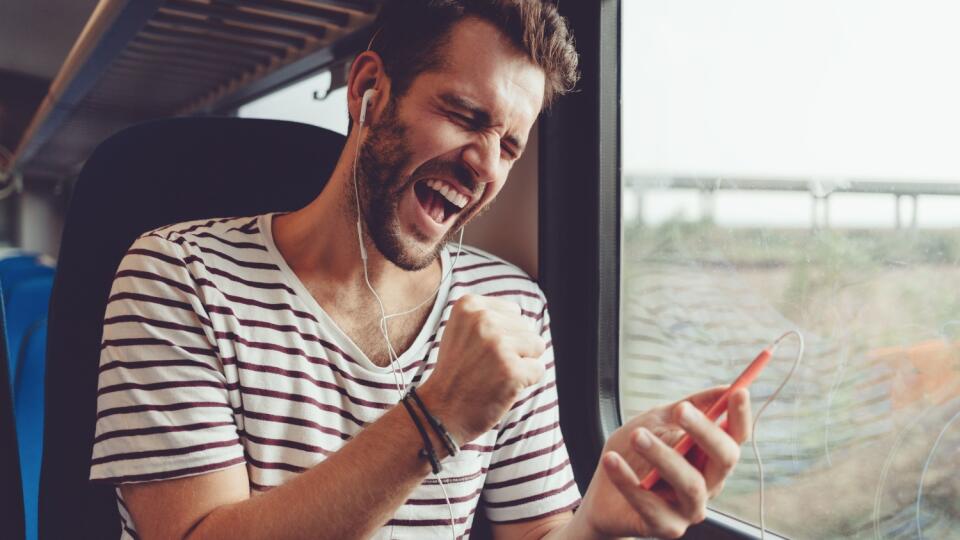 Young man listening to the music on the train