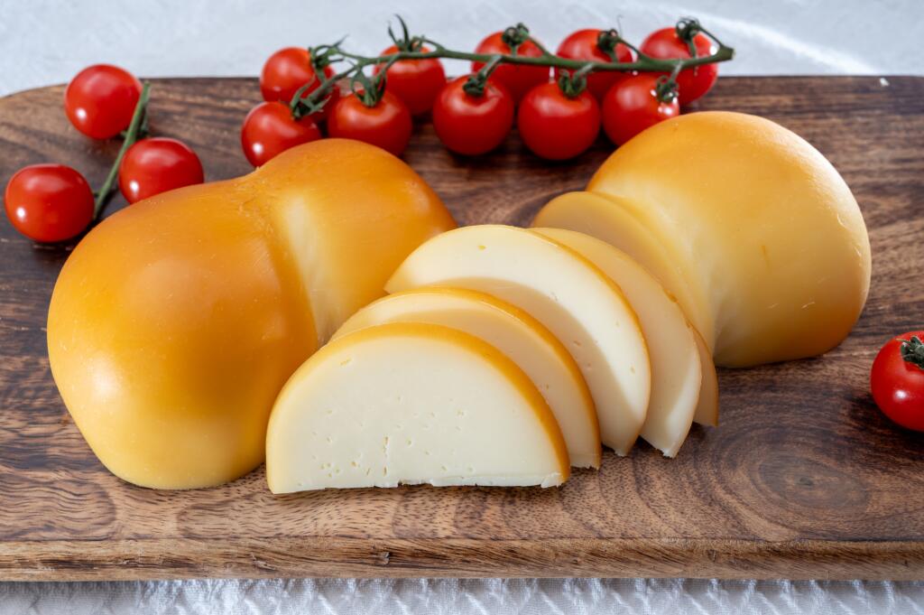 Cheese collection, Italian cheese scamorza, caciocavallo, provolone made from cow milk in South Italy yellow smoked cheese close up