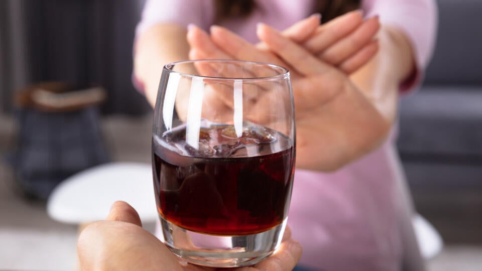 Close-up,Of,A,Woman's,Hand,Refusing,Glass,Of,Drink,Offered