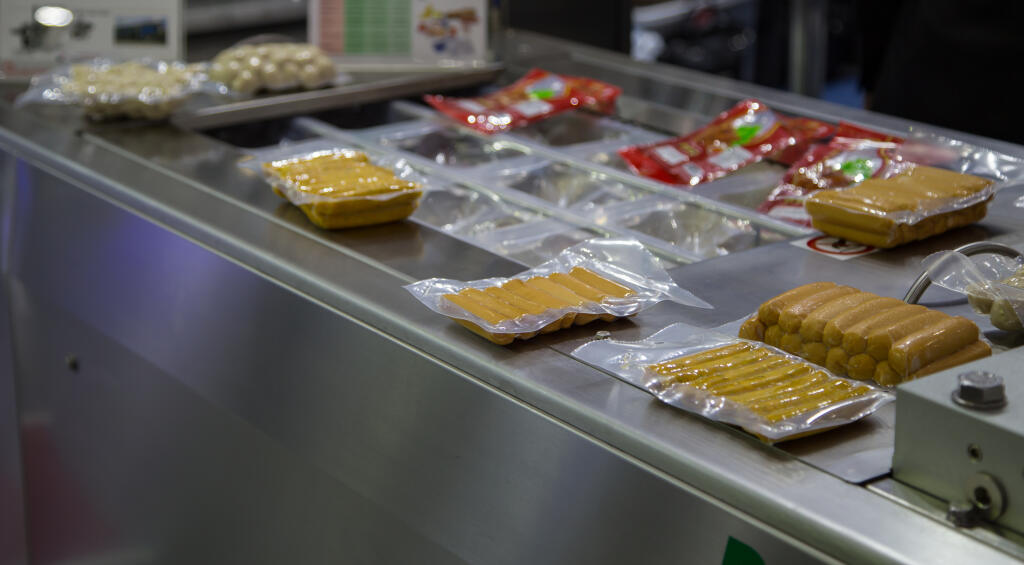 Packing,Of,Food,Sausage,In,Production,Line