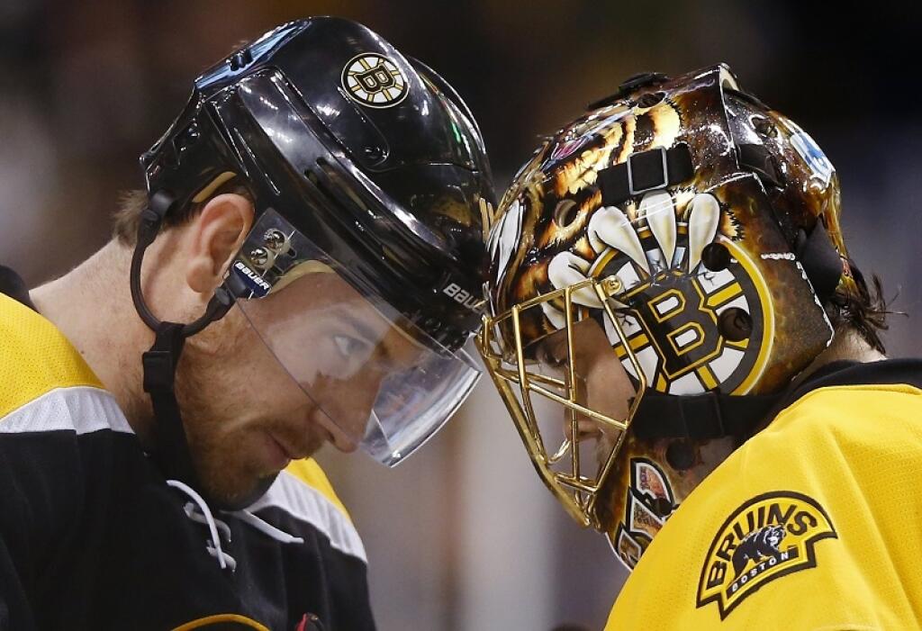 Boston Bruins' Jimmy Hayes, left, congratulates goalie Tuukka Rask after their 3-0 win over the Pittsburgh Penguins in an NHL hockey game in Boston Wednesday, Dec. 16, 2015. (AP Photo/Winslow Townson)
