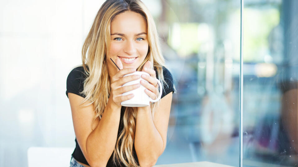 Woman,Drinking,Coffee,In,The,Morning,At,Restaurant,(soft,Focus