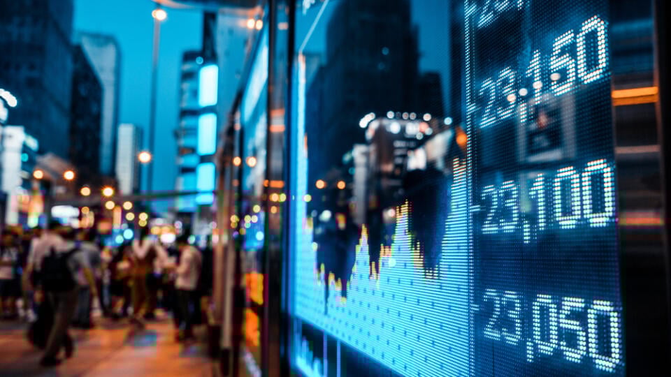 Display,Of,Stock,Market,Quotes,With,City,Scene,Reflect,On