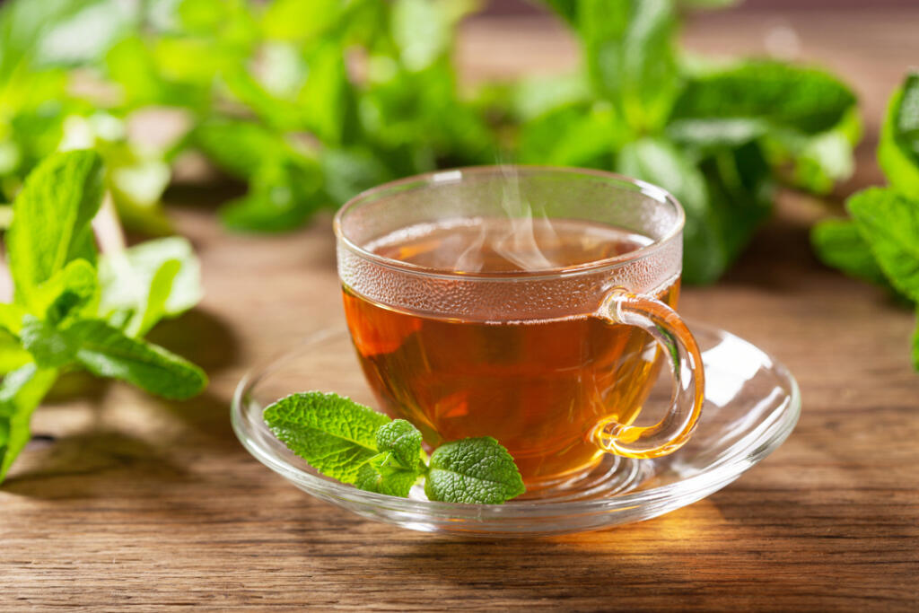 Hot,Cup,Of,Tea,With,Mint,On,Wooden,Table