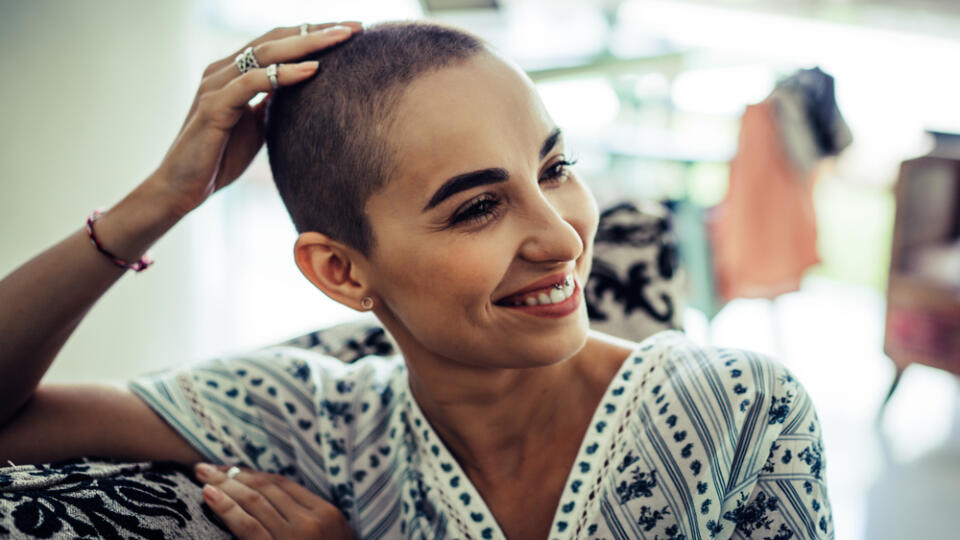 Portrait,Of,A,Bald,Woman,In,A,Living,Room,In