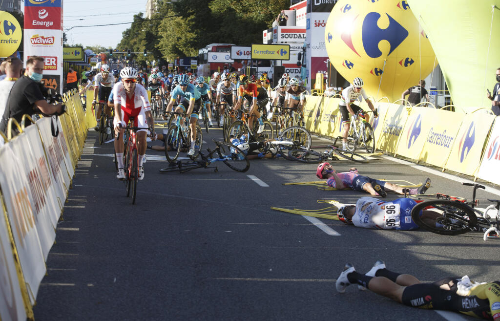 KK8 Katovice - Na snímke cyklisti ležia zranení na zemi po kolízii v závere úvodnej etapy 77. ročníka pretekov Okolo Poľska 5. augusta 2020 v Katoviciach. Holandský cyklista Fabio Jakobsen (Deceuninck-Quickstep) bojuje v o život po hrozivom páde v závere úvodnej etapy 77. ročníka pretekov Okolo Poľska. Okrem neho sa zranilo aj viacero ďalších jazdcov. Dvadsaťtriročný Jakobsen narazil a preletel cez bariéru pár metrov pred cieľom po súboji so svojím krajanom Dylanom Groenewegenom, ktorého za jeho