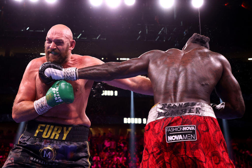 LAS VEGAS, NEVADA - OCTOBER 09: Tyson Fury (L) exchanges punches with Deontay Wilder during their WBC heavyweight title fight at T-Mobile Arena on October 09, 2021 in Las Vegas, Nevada. (Photo by Al Bello/Getty Images)
