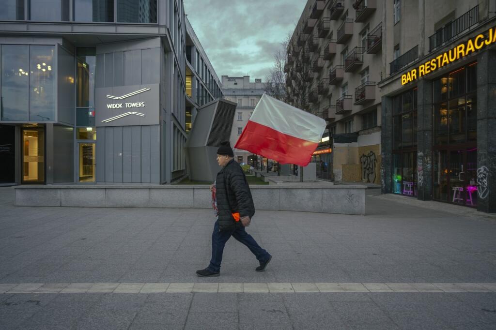Na snímke muž nesie poľskú vlajku počas protestu farmárov vo Varšave.