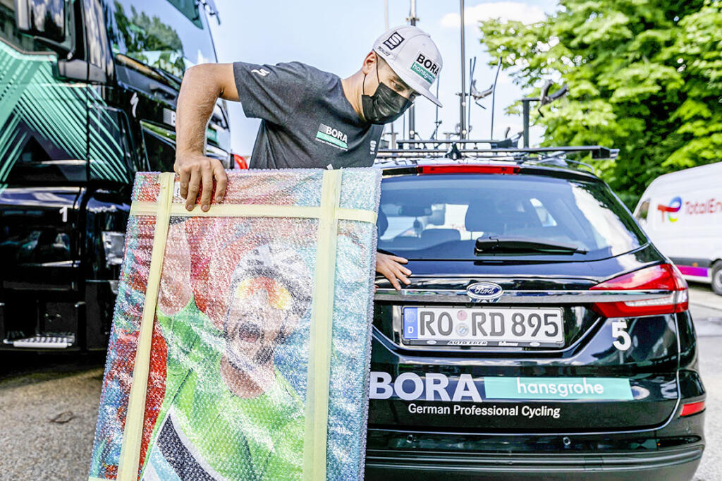 Peter Sagan v meste Nîmes, kde dostal obraz od slovenskej  
 fanúšičky. Ide o reprodukciu fotografie z roku 2018,  
 keď sa mu podarilo vyhrať 13. stapu.