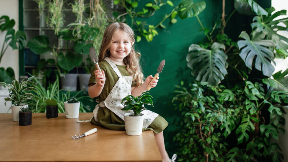 Little,Happy,Blonde,Girl,Plant,Green,Plants,In,The,Greenhouse.