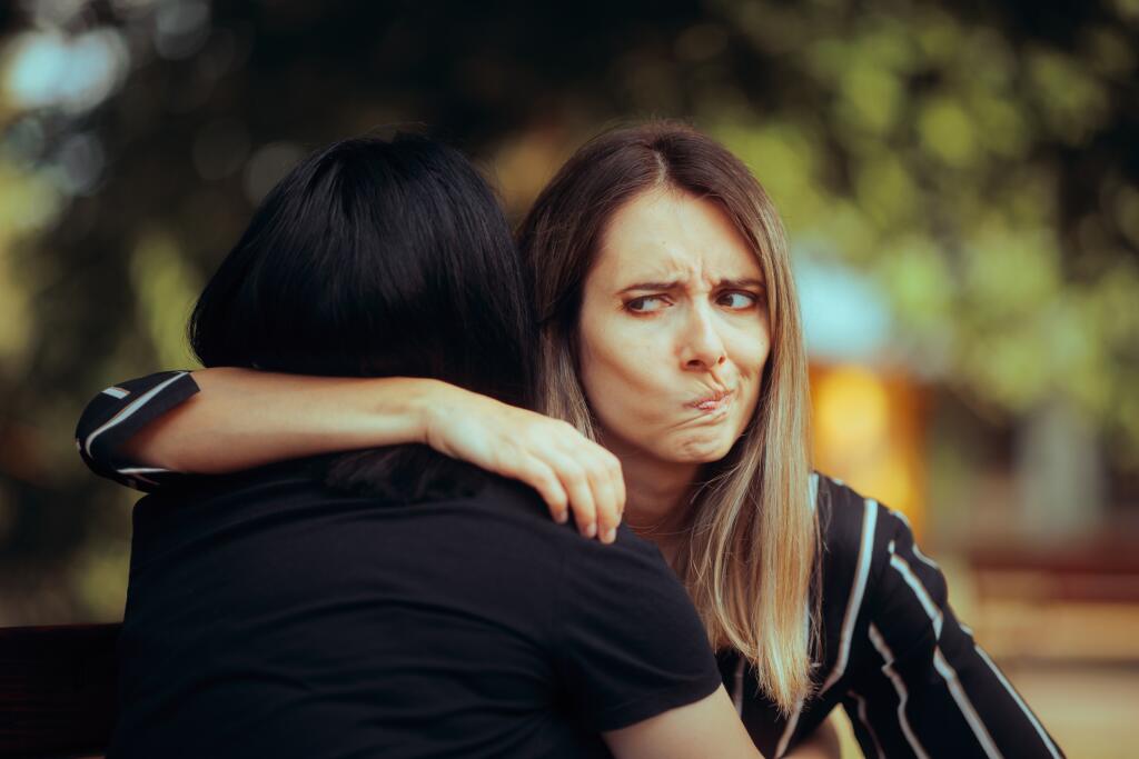 Woman,Hugs,Fake,Friend,Making,Faces,Behind,Her,Back,Backstabbing