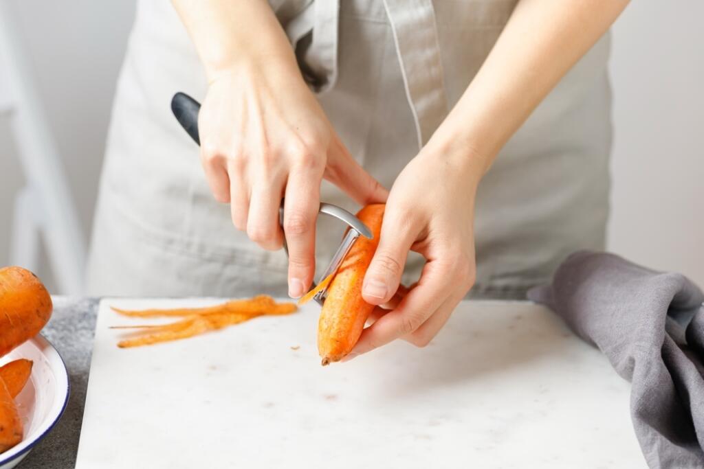 Hands,Cut,Carrot,On,Marble,Board.,Woman,In,Apron,Cut