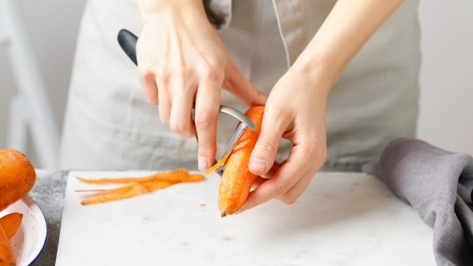 Hands,Cut,Carrot,On,Marble,Board.,Woman,In,Apron,Cut