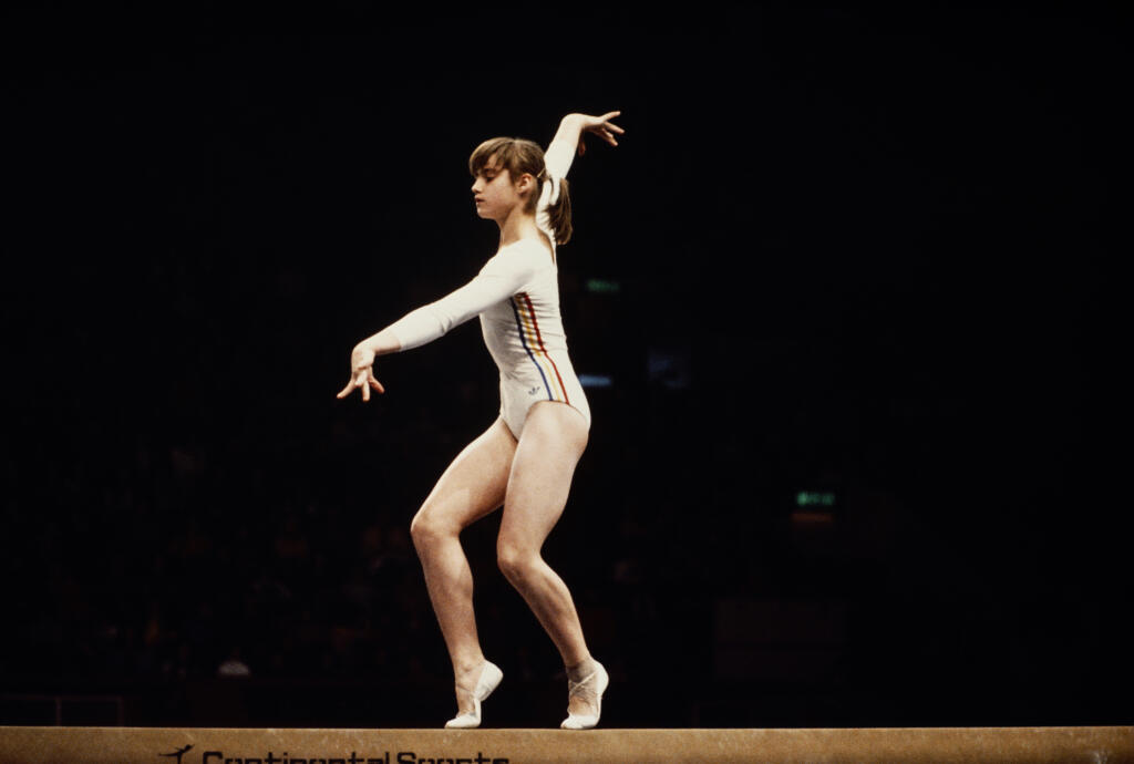Nadia Comaneci of Romania performs her routine on the Balance Beam during the Women's ArtisticTeam all-around event on 19 July 1976 during the XXI Olympic Summer Games at the Montreal Forum, Montreal, Canada. (Photo by Don Morley/Getty Images) )