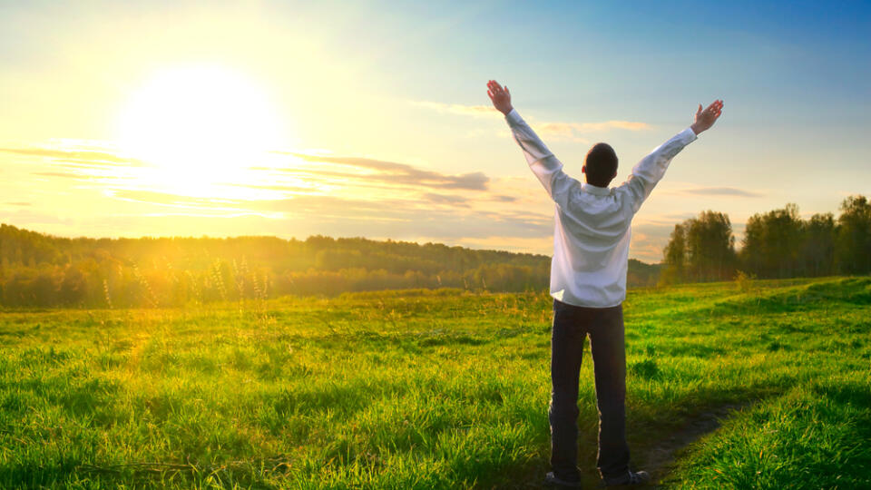 Happy,Man,With,Hands,Up,On,Sunset,Background