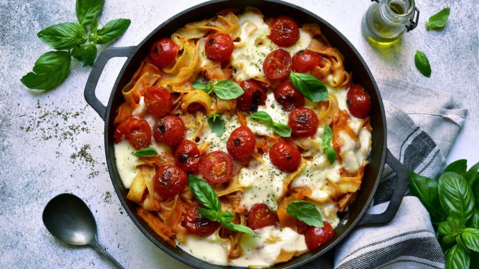 Pasta,Casserole,With,Tomatoes,And,Mozzarella,Cheese,In,A,Black