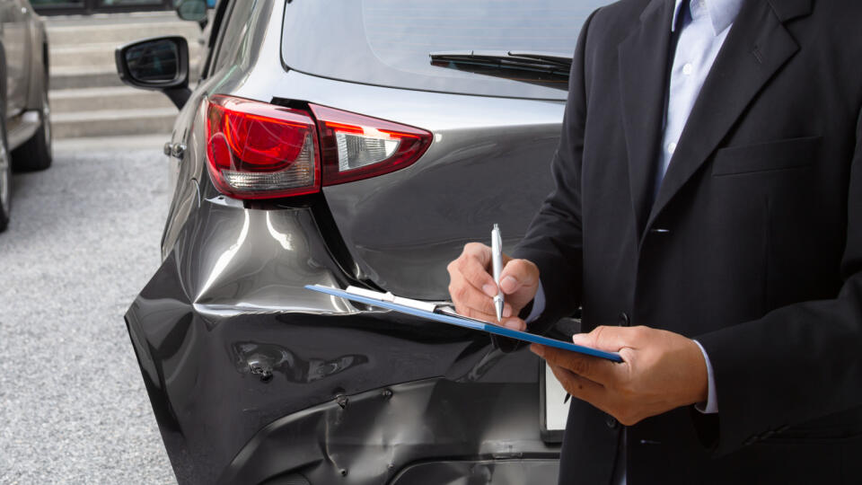 Side,View,Of,Insurance,Officer,Writing,On,Clipboard,While,Insurance
