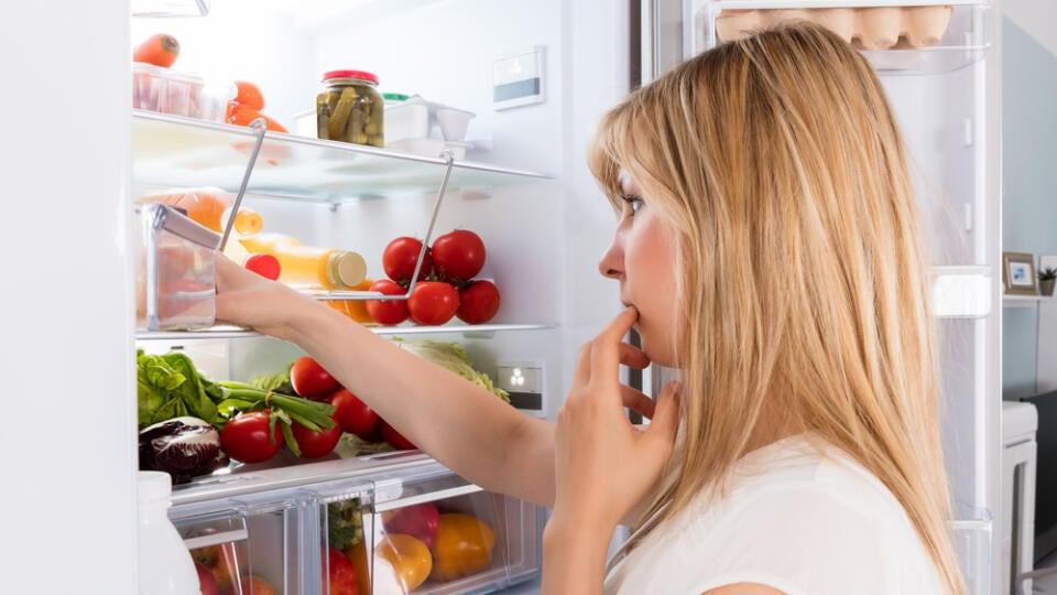 Young,Woman,Looking,In,Fridge,At,Kitchen