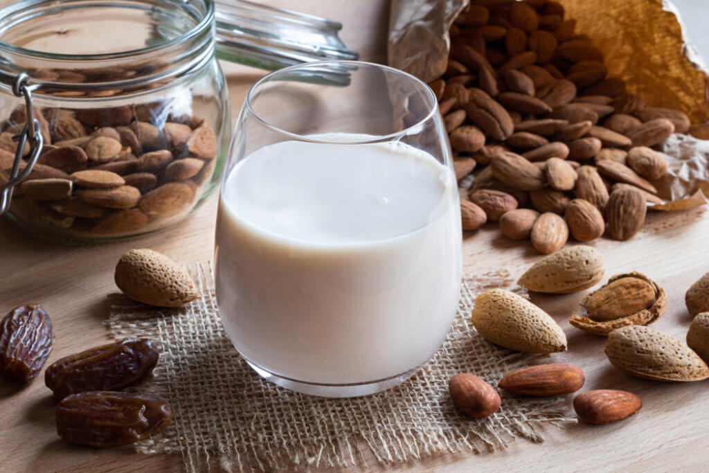 A,Glass,Of,Almond,Milk,On,A,Wooden,Table,With