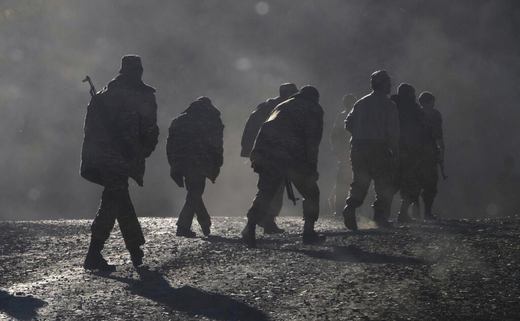 JB 36 Stepanakert - Na snímke etnickí arménski vojaci kráčajú pri ceste neďaleko hranice medzi Náhorným Karabachom a Arménskom počas bojov medzi arménskymi a azerbajdžanskými vojenskými jednotkami v samozvanom regióne Náhorný Karabach 8. novembra 2020. V spornom regióne Náhorného Karabachu, enkláve na území Azerbajdžanu s prevažne arménskym obyvateľstvom, pokračovali v nedeľu boje medzi arménskymi a azerbajdžanskými silami. Pod paľbou sa opäť ocitla karabašská metropola Stepanakert, ako aj druhé
