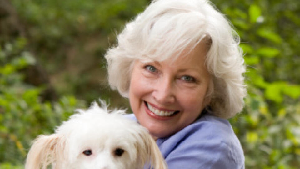 Portrait of senior woman holding dog