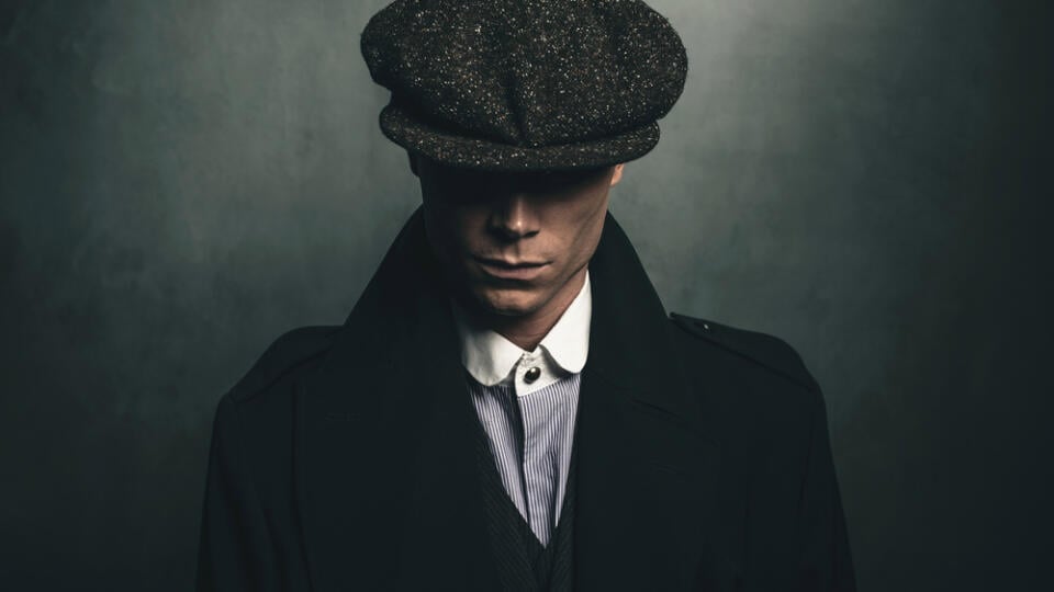 Mysterious,Portrait,Of,Retro,1920s,English,Gangster,With,Flat,Cap.