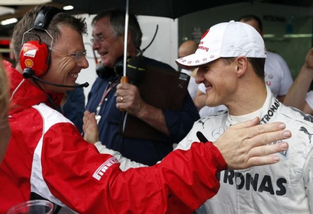 Mercedes Grand Prix driver Michael Schumacher, right, of Germany, is greeted by a mechanic of team Ferrari after competing in the Formula One Brazilian Grand Prix at the Interlagos race track in Sao Paulo, Brazil, Sunday, Nov. 25, 2012. Schumacher, a seven-time world champion, retired after the race. (AP Photo/Victor R. Caivano