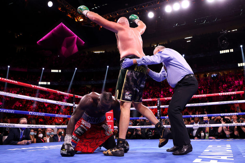 LAS VEGAS, NEVADA - OCTOBER 09: Tyson Fury (top) reacts after knocking down Deontay Wilder during their WBC heavyweight title fight at T-Mobile Arena on October 09, 2021 in Las Vegas, Nevada. (Photo by Al Bello/Getty Images)