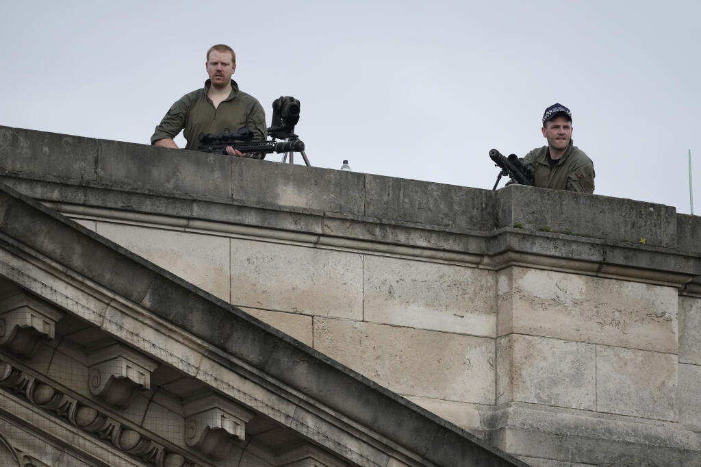 Snipers are stationed on the roof of Buckingham Palace.
