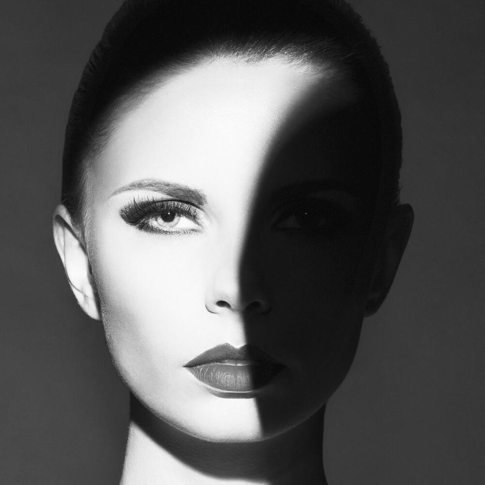 Fashion art studio portrait of elegant naked lady with shadow on her body