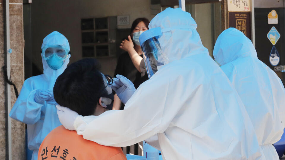 KK21 Soul - Zdravotník v ochrannom obleku odoberá mužovi vzorku na ochorenie Covid-19, 5. júna 2020 v Soule. FOTO TASR/AP
A health official wearing protective gear takes samples from a man during the COVID-19 testing at a makeshift clinic in Seoul, South Korea, Friday, June 5, 2020. (AP Photo/Ahn Young-joon)