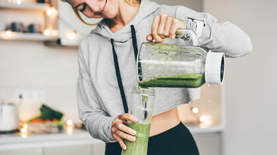 Woman,Making,Detox,Smoothie,At,Home.,Woman,Pouring,Smoothie,To