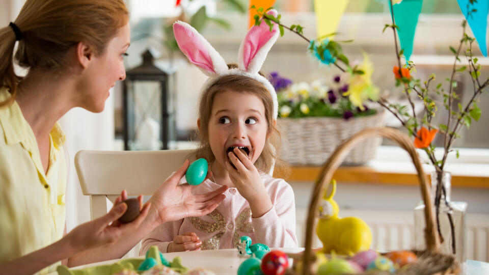 Mother,And,Daughter,Celebrating,Easter,,Eating,Chocolate,Eggs.,Happy,Family