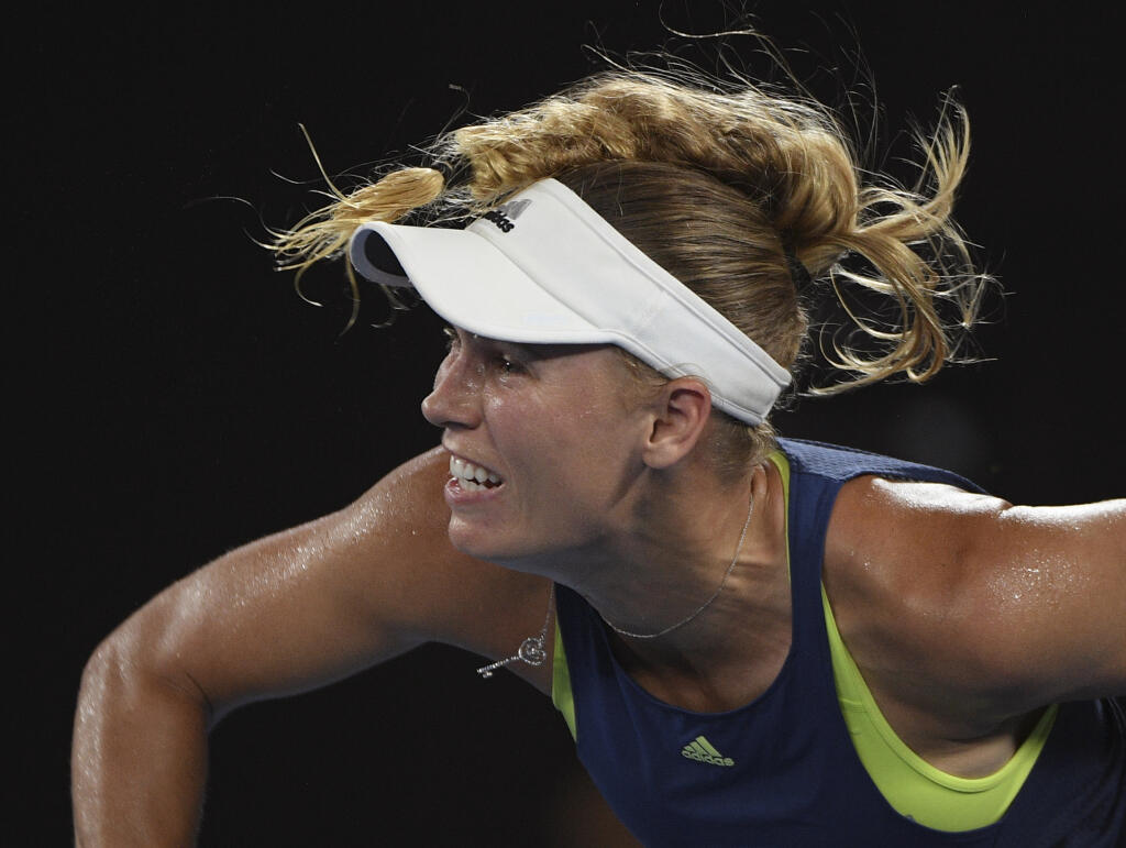 Denmark's Caroline Wozniacki serves to Romania's Simona Halep during the women's singles final at the Australian Open tennis championships in Melbourne, Australia, Saturday, Jan. 27, 2018. (AP Photo/Andy Brownbill)