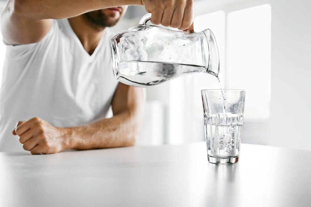 Drink,Water.,Close,Up,Of,Handsome,Young,Man,Pouring,Fresh