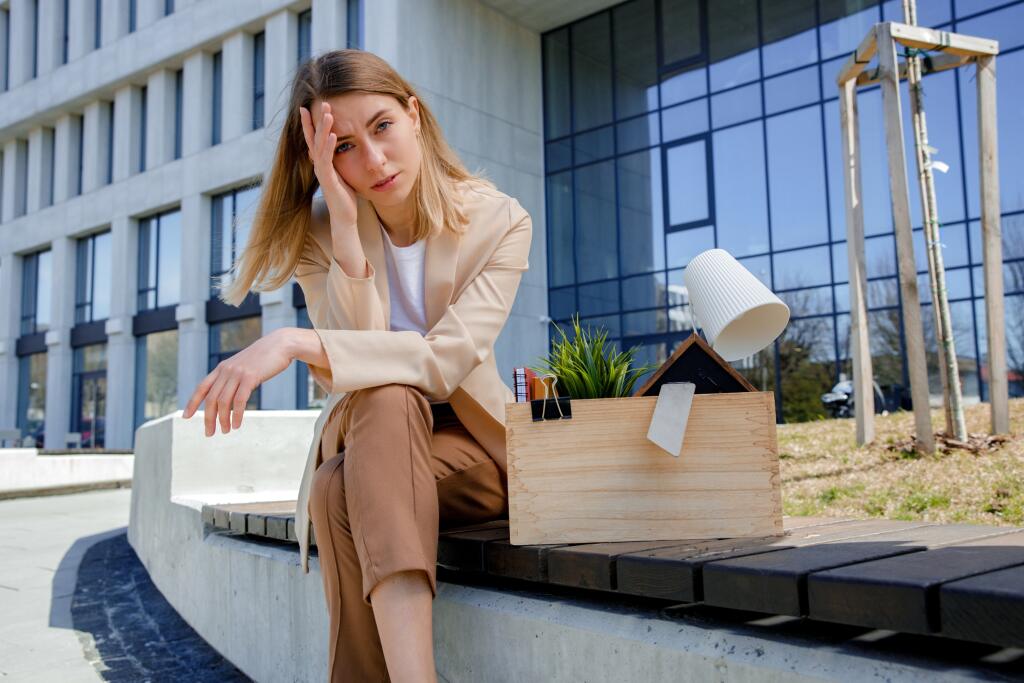Frustrated,Sad,Woman,Sitting,On,Bench,With,Box,Of,Personal
