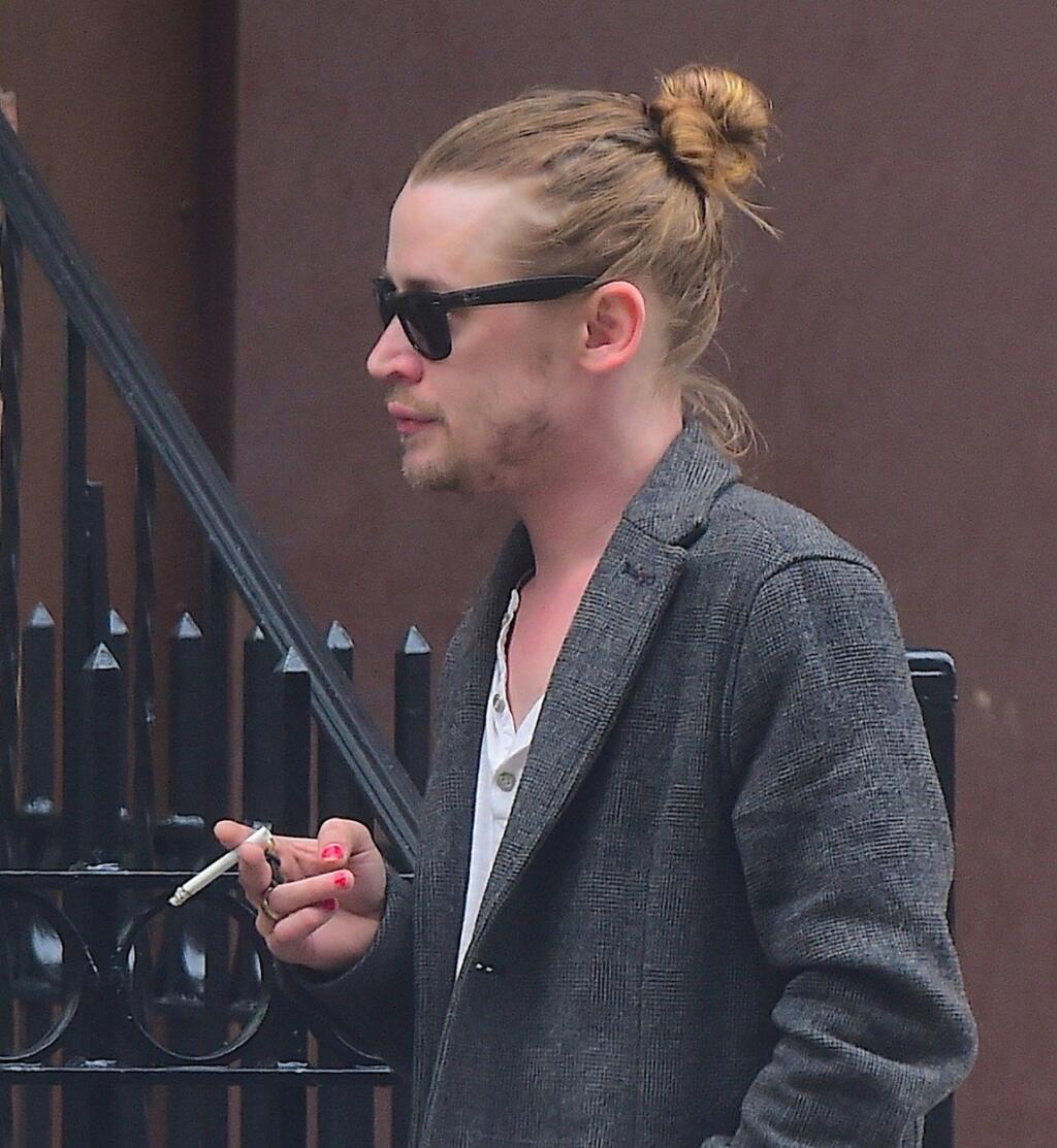 EXCLUSIVE: Macaulay Culkin was spotted out in Soho on Saturday Afternoon. The Child star was seen on a rare public outing, smoking on a cigarette as he walked to Smile Cafe . He showed off his shocking Red Nail Polish, which was semi-chipped. He put his long locks up into a messy bun, as he went incognito in a pair of sunglasses. Pictured: Macaulay Culkin, Image: 283666427, License: Rights-managed, Restrictions: -ALLCOUNTRY,-StpFmP, Model Release: no, Credit line: Profimedia, Splash