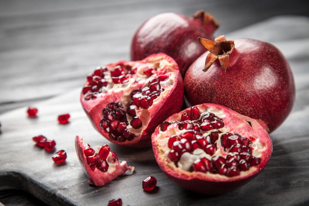 Red,Juice,Pomegranate,On,Dark,Background