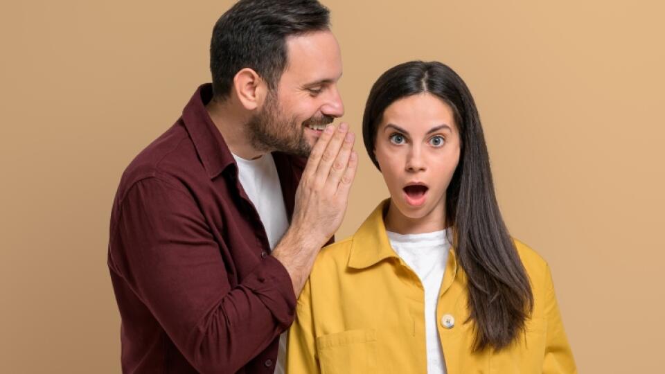 Shocked,Woman,With,Mouth,Open,Listening,To,Man,Telling,Secrets