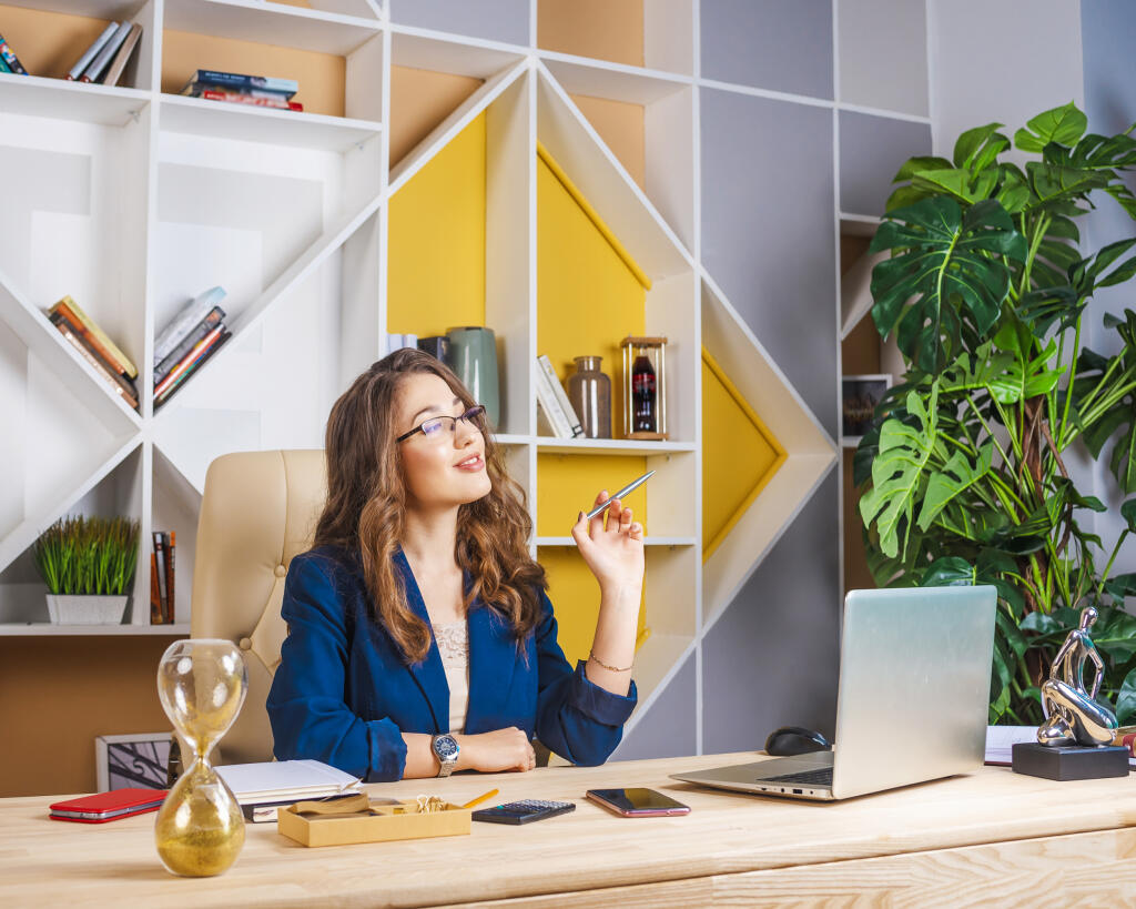Successful,Businesswoman,Working,With,Laptop,In,Office