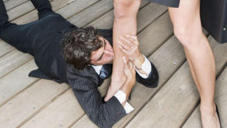 Businessman Kissing Businesswoman's Leg