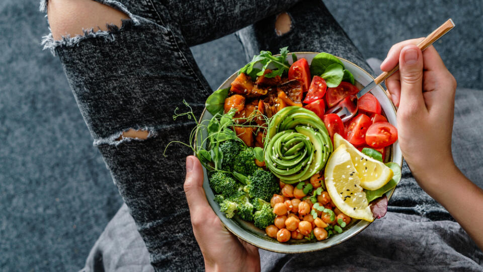 Woman,In,Jeans,Holding,Buddha,Bowl,With,Salad,,Baked,Sweet