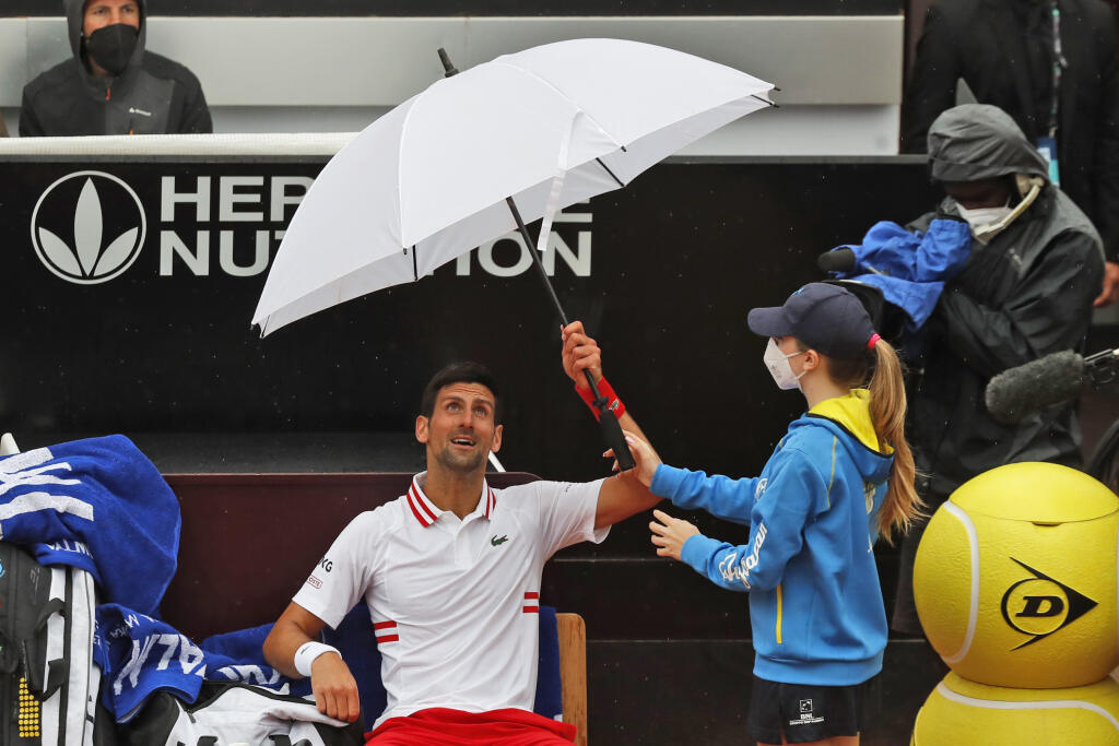 JB 26 Rím - Srbský tenista Novak Djokovič drží dáždnik v prestávke zápasu proti Američanovi Taylorovi Fritzovi v 1. kole dvojhry na tenisovom turnaji ATP v Ríme 11. mája 2021. FOTO TASR/AP
Novak Djokovic of Serbia holds an umbrella during a pause of his match against Taylor Fritz of the United States at the Italian Open tennis tournament, in Rome, Tuesday, May 11, 2021. (AP Photo/Alessandra Tarantino)