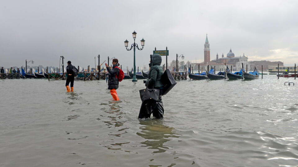 EBE 30 Benátky - Na snímke turisti sa brodia v zaplavených Benátkach 13. novembra 2019. Voda zaplavila viac než 85 percent rozlohy mesta. Úplne zaplavené bolo Námestie svätého Marka ležiace na jednom z najnižších miest v Benátkach. Voda prenikla aj do Baziliky svätého Marka a spôsobila škody na murive budovy. FOTO TASR/AP
People walk in high water, in Venice, Italy, Wednesday, Nov. 13, 2019. The high-water mark hit 187 centimeters (74 inches) late Tuesday, meaning more than 85% of the city was f