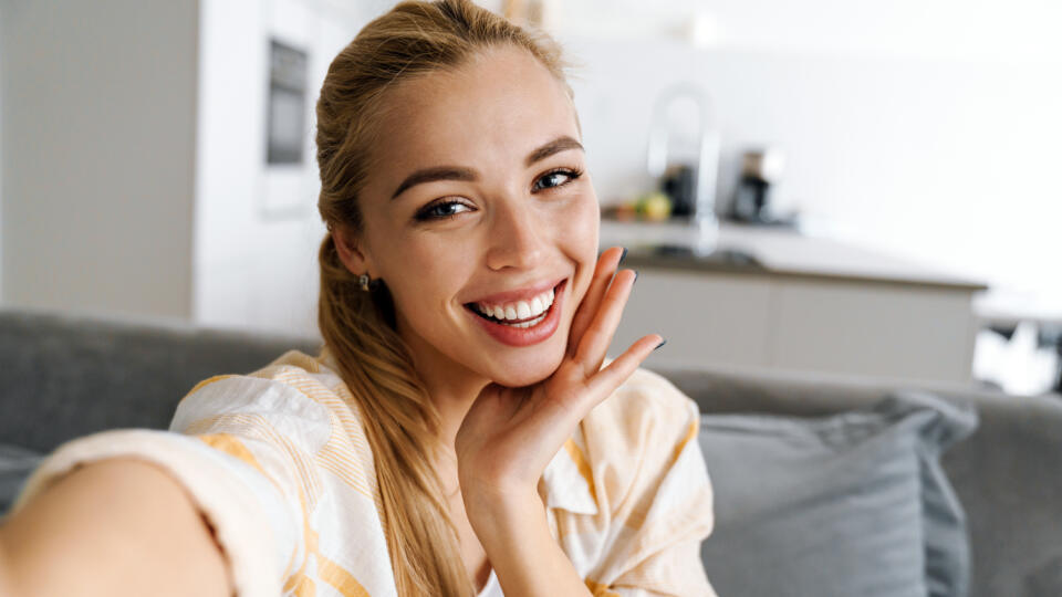 Happy,Blonde,Woman,Smiling,While,Taking,Selfie,Photo,At,Home