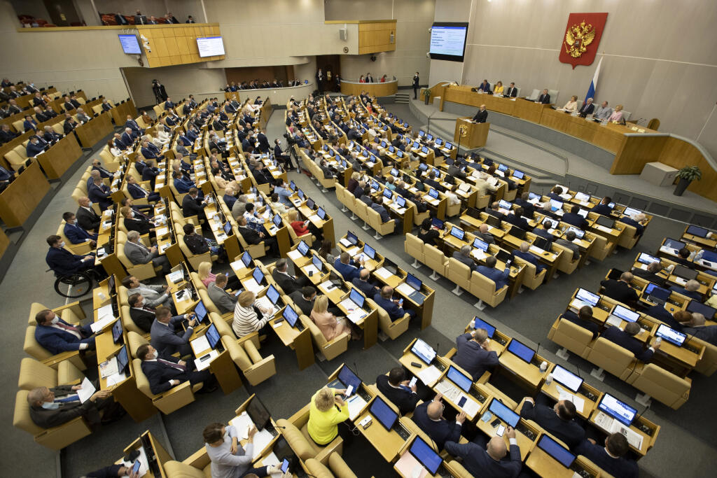 EBE 18 Moskva - Na snímke napravo v pozadí ruský premiér Michail Mišustin počas výročnej správy o hospodárskom a sociálnom rozvoji krajiny v dolnej komore ruského parlamentu, Štátnej dume v Moskve 22. júla 2020. FOTO TASR/AP 
Prime Minister Mikhail Mishustin addresses the State Duma, the Lower House of the Russian Parliament from the podium with an annual report on the country's economic and social development, in Moscow, Russia, Wednesday, July 22, 2020. (AP Photo/Alexander Zemlianichenko)