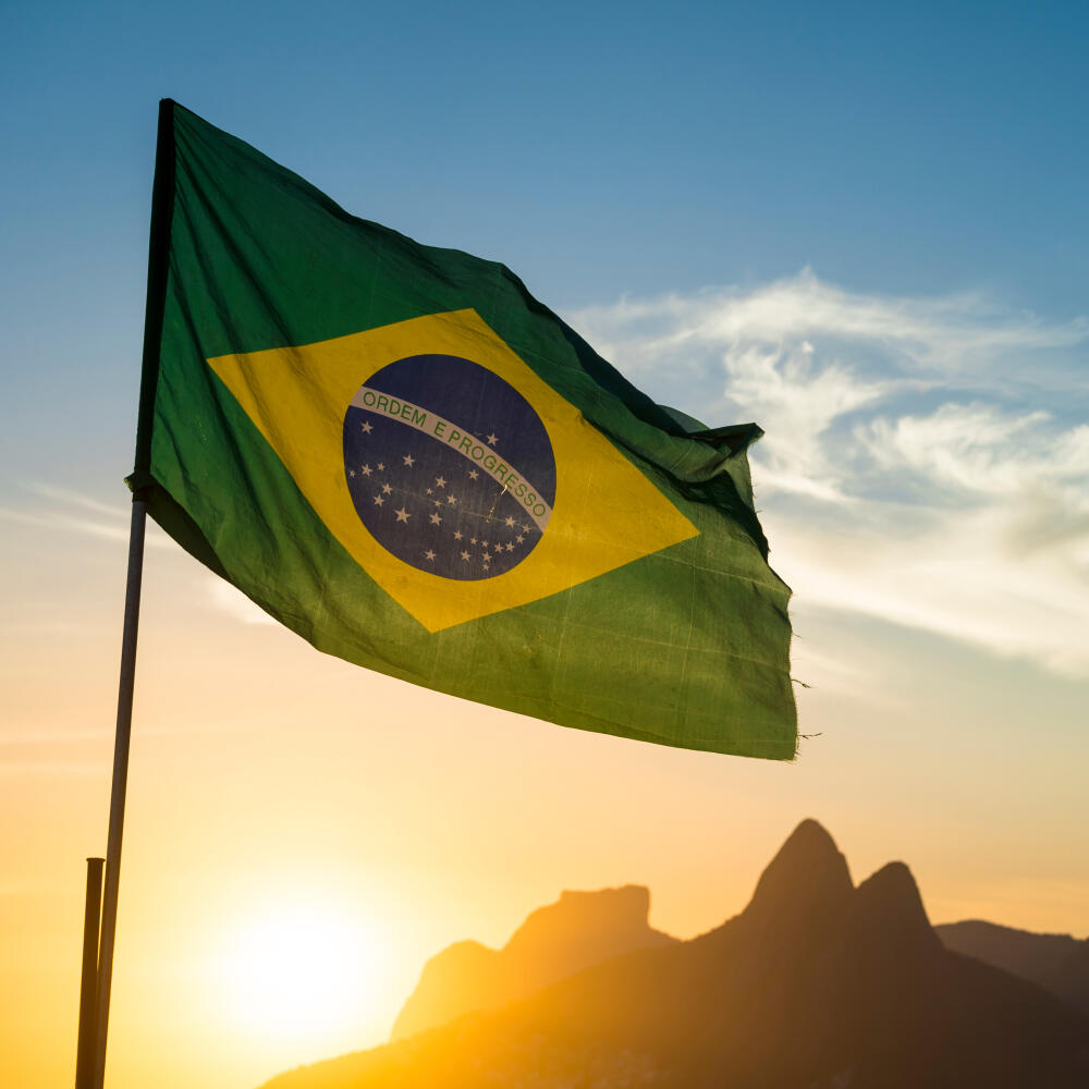 Brazilian,Flag,Waving,Backlit,In,Front,Of,The,Golden,Sunset
